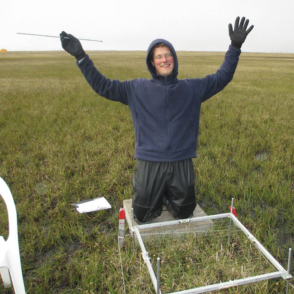 Tim celebrates after finishing his measurements on a plot.